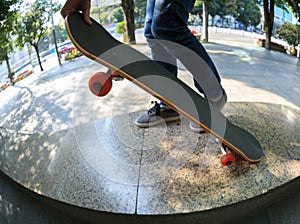 Skateboarder legs riding skateboard