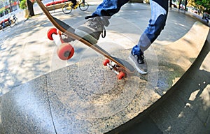 Skateboarder legs riding skateboard