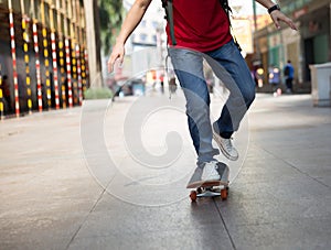 Skateboarder legs riding skateboard