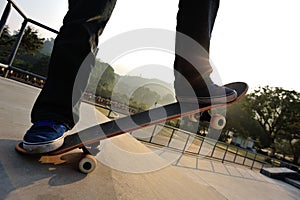 Skateboarder legs riding skateboard