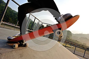 Skateboarder legs riding skateboard