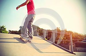 Skateboarder legs riding skateboard