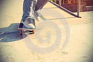 Skateboarder legs riding skateboard