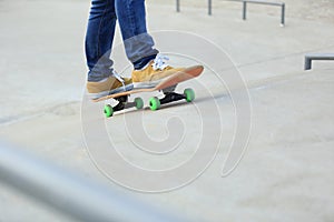 Skateboarder legs riding skateboard