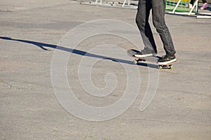 Skateboarder legs riding skateboard