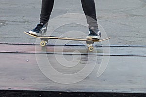 Skateboarder legs riding skateboard