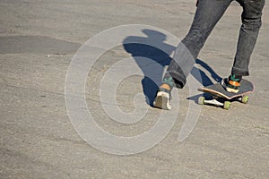 Skateboarder legs riding skateboard