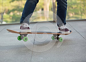 Skateboarder legs riding skateboard outdoor