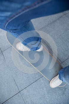 Skateboarder legs riding skateboard