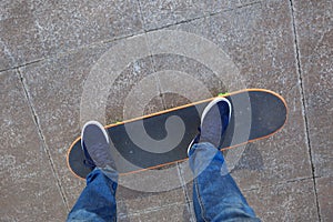 skateboarder legs riding skateboard at skatepark