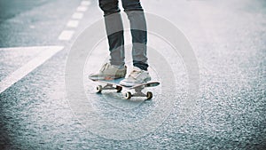 Skateboarder legs riding skateboard on the street