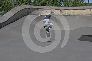 Skateboarder performing a kickflip photo