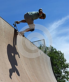 Skateboarder performing stunt on Vert Ramp.