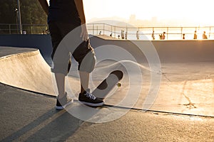 Skateboarder photographed against the light during sunset