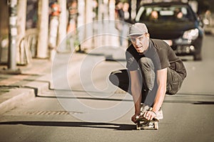 Skateboarder ride a skateboard slope through the city street