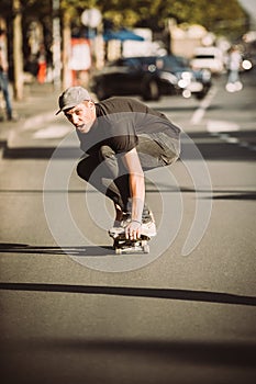 Skateboarder ride a skateboard slope through the city street