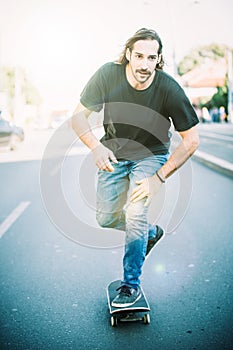 Skateboarder ride a skateboard slope through the city street