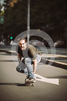 Skateboarder ride a skateboard slope through the city street