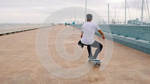 Skateboarder rides a skateboard in the modern city terrace.