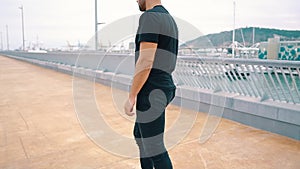 Skateboarder rides a skateboard in the modern city terrace.