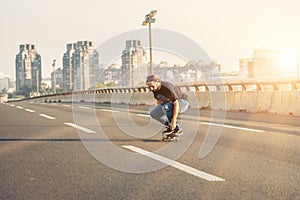 Skateboarder riding a skate over a city road bridge. Free ride s