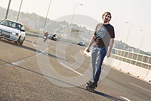 Skateboarder riding a skate over a city road bridge. Free ride s