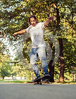 Skateboarder riding a skateboard on the two wheels
