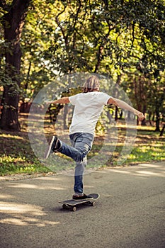 Skateboarder riding a slope through the forest