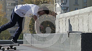 Skateboarder try a grind trick on ledge and skate truck stops slide, slowmotion