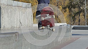 Skateboarder try a grind trick on ledge and skateboard jumps off