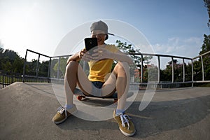 Skateboarder using mobile phone