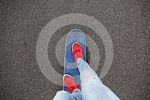 Skateboarders feet while skating through the street