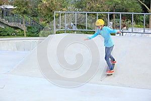 Skateboarders ridng on a skateboard park