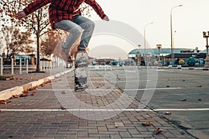 Skateboarding. A man does an Ollie stunt on a skateboard. Jump in the air. Close-up of legs