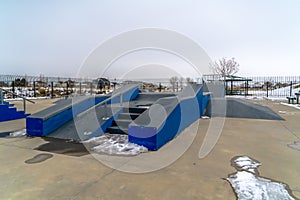 Skateboarding ramp against snowy landscape and sky