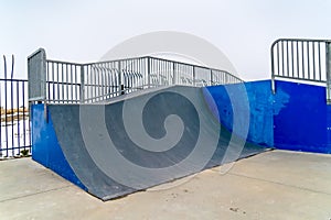 Skateboarding ramp with snow and sky background