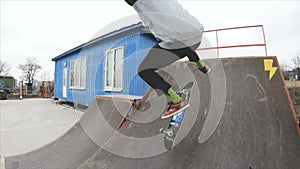 Skateboarding teenager man in skatepark extreme sport in slow motion 4K. Taken on Gopro 6 black