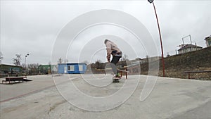 Skateboarding teenager man in skatepark extreme sport in slow motion 4K. Taken on Gopro 6 black