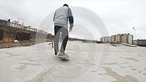 Skateboarding teenager man in skatepark extreme sport in slow motion 4K. Taken on Gopro 6 black