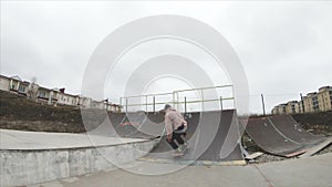 Skateboarding teenager man in skatepark extreme sport in slow motion 4K. Taken on Gopro 6 black