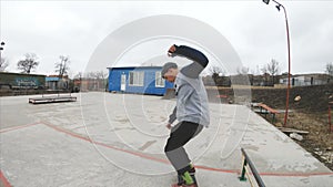 Skateboarding teenager man in skatepark extreme sport in slow motion 4K. Taken on Gopro 6 black