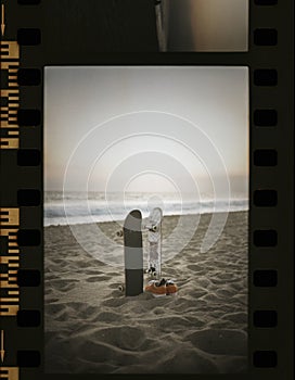 Skateboards at the beach in a film strip