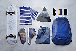 Skater boy outfit, style or fashion laid out on the floor looking edgy, trendy and fashionable with a skateboard top