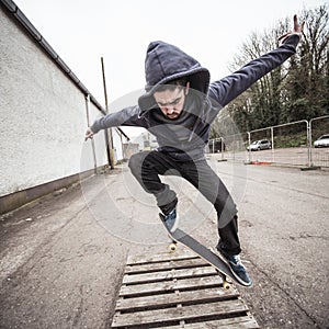 Skater doing ollie over wooden crate