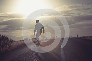 Skater on empty road with maks in Iceland. Great light in the ba