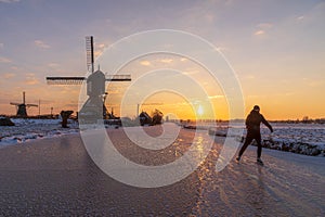 Skater on the frozen canal along the windmills alignment