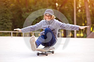 Skater girl on skatepark moving on skateboard outdoors