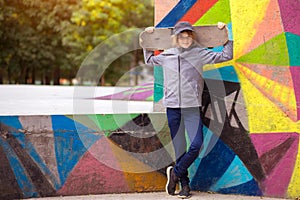 Skater girl on skatepark moving on skateboard outdoors