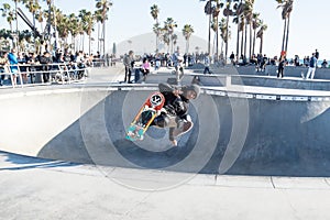 Skater jumping at Venice Beach skatepark, Venice Beach, Los Angeles, California