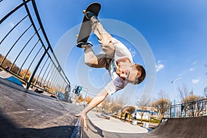 Skater make handplant in mini ramp in skatepark